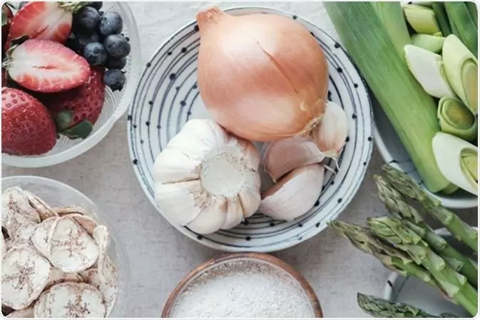 Variety of prebiotic foods, raw green banana, asparagus, onions, garlic, leeks, berries and green beans. Image Credit: SewCream / Shutterstock Variety of prebiotic foods, raw green banana, asparagus, onions, garlic, leeks, berries and green beans. Image Credit: SewCream / Shutterstock